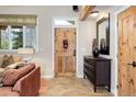 Cozy foyer with stone tile, wooden door, and natural light at 9445 Lykins Pl, Longmont, CO 80503