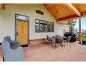 Inviting outdoor patio with stone flooring, comfortable seating, and a grill at 9445 Lykins Pl, Longmont, CO 80503