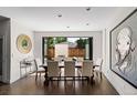Bright dining room with large table, ample seating, and doors opening to the outdoors at 2564 S Carey Way, Denver, CO 80222