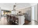 Stylish kitchen featuring stainless steel appliances, breakfast bar, and modern pendant lighting at 2564 S Carey Way, Denver, CO 80222