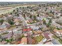 An aerial view of a suburban neighborhood featuring mature trees, well-maintained homes, and green spaces at 14867 E Harvard Ave, Aurora, CO 80014