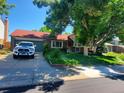Well-maintained single Gathering home in a suburban neighborhood with a spacious front yard and mature trees at 14867 E Harvard Ave, Aurora, CO 80014