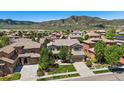Beautiful aerial view of a two-story home nestled in a lush suburban neighborhood with scenic mountain backdrop at 2263 S Loveland St, Lakewood, CO 80228