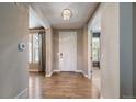 Inviting foyer with hardwood floors, a stylish light fixture, and a white front door at 2263 S Loveland St, Lakewood, CO 80228