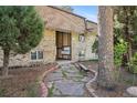 Apartment building entrance with mailbox, stone pathway and bench at 1390 Everett Ct # 105, Lakewood, CO 80215