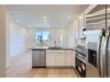 Stylish kitchen with stainless steel appliances, ample cabinetry, and a breakfast bar at 1965 S Haleyville Way, Aurora, CO 80018
