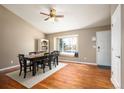 Bright dining room featuring beautiful hardwood floors, ample natural light, and adjacent front door at 200 N Holcomb St, Castle Rock, CO 80104