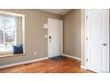 Welcoming entryway with hardwood floors, window seat, and a white front door providing a warm and inviting space at 200 N Holcomb St, Castle Rock, CO 80104