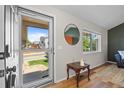 Welcoming entryway with hardwood floors, stylish mirror, and a bright view of the front yard at 20858 E Progress Ave, Centennial, CO 80015