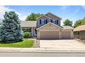 Charming two-story home with a brick-accented facade and a spacious three-car garage at 20858 E Progress Ave, Centennial, CO 80015
