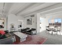 Bright living room with city views, leather furniture, and a stylish coffee table at 130 N Pearl St # 404, Denver, CO 80203