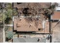 Aerial view of home with a large brown roof, stone patio, surrounded by mature trees and neighboring houses at 4267 Federal Blvd, Denver, CO 80211