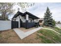 Corner view of a charming home with a covered porch, black and white brick, and landscaped front yard at 4267 Federal Blvd, Denver, CO 80211
