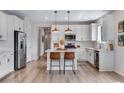 Modern kitchen featuring stainless steel appliances, a center island, and pendant lighting at 944 Alpine Ridge St, Erie, CO 80516