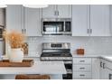 Close-up of a kitchen with quartz counters, stainless appliances, and modern fixtures at 944 Alpine Ridge St, Erie, CO 80516