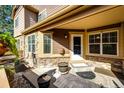 Inviting front porch area with decorative stone, neutral siding, and an entryway with a welcome mat at 5660 S Algonquian Way # C, Aurora, CO 80016