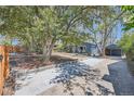 Charming home with a long driveway, mature trees and lush landscaping offering ample parking space at 2942 Chase St, Wheat Ridge, CO 80214
