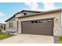 Charming single Gathering home featuring a two-car garage with stone accents at 23692 E 40Th Ave, Aurora, CO 80019