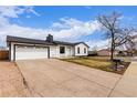 Well-maintained single-story home with a spacious driveway leading to an attached two-car garage at 16555 E Wesley Ave, Aurora, CO 80013