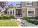 Inviting front entrance with a stylish front door, brick accents, and a well-maintained walkway at 1274 Meyerwood Ln, Highlands Ranch, CO 80129