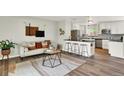 A cozy living room and kitchen area with modern decor, hardwood floors, and neutral tones at 400 S Hoyt St, Lakewood, CO 80226