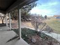 View from covered patio shows a fenced yard and rock wall at 7101 W Yale Ave # 1206, Denver, CO 80227