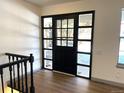 Bright entryway with hardwood floors and a black door at 7101 W Yale Ave # 1206, Denver, CO 80227