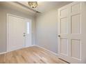 Bright entryway with hardwood floors, a decorative light fixture, and a coat closet at 45 Wright Ct, Lakewood, CO 80228