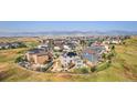 Panoramic aerial view showcasing the community nestled amidst rolling hills, with stunning mountain views in the background at 8551 Orchard Way, Arvada, CO 80007