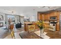 Inviting kitchen with wood cabinets, stainless steel appliances, and open layout to living spaces at 10818 Cimarron St # 1102, Firestone, CO 80504