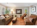 Cozy living room featuring hardwood floors, neutral paint, and abundant natural light at 2 S Monroe St, Denver, CO 80209