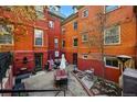 Charming brick backyard featuring patio seating, garden area and outdoor gathering space at 1165 N Pennsylvania St # G2, Denver, CO 80203