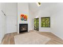 Bright living room features a cozy fireplace, skylight, and door to entry at 4850 E Kentucky Ave # C, Denver, CO 80246