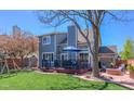 Spacious backyard with a well-manicured lawn, a patio with outdoor seating, and a storage shed at 14533 W 69Th Pl, Arvada, CO 80004