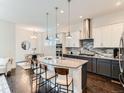 Modern kitchen boasts granite countertops, stainless steel appliances, and stylish two-tone cabinetry at 10479 E 25Th Dr, Aurora, CO 80010