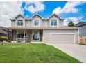 Charming two-story home featuring stone accents, three dormer windows, and a well-manicured lawn at 5573 S Taft St, Littleton, CO 80127
