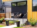 Charming front porch with modern railings, stylish outdoor seating, and manicured landscaping, leading to the front entrance at 2025 Fenton St, Edgewater, CO 80214