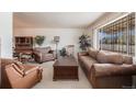 Cozy living room featuring comfortable seating and a large window with security bars at 1010 Kennedy Dr, Westminster, CO 80234
