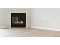 Close up view of the fireplace with white tile surround and dark firebox at 7440 S Blackhawk St # 2-203, Englewood, CO 80112