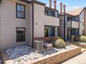 Charming condo exterior boasting well-kept landscaping, private balconies, and convenient stairway access at 12053 E Harvard Ave # 107, Aurora, CO 80014