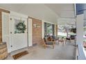 Comfortable seating area on a covered front porch, perfect for relaxing outdoors at 12821 W 60Th Ave, Arvada, CO 80004