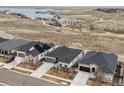 Aerial view of homes in a community near a lake with walking paths and open space at 26741 E Peakview Pl, Aurora, CO 80016