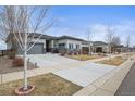 Beautiful single Gathering home with a stone facade, well-manicured lawn, and a spacious driveway at 26741 E Peakview Pl, Aurora, CO 80016