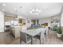 Bright open-concept with modern kitchen, dining, and living area; hardwood floors, granite countertops, stainless steel appliances, and ample natural light at 26741 E Peakview Pl, Aurora, CO 80016