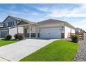 Charming home exterior featuring a well-maintained lawn and a convenient two-car garage at 7222 Aspen Brook Ave, Frederick, CO 80530