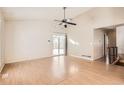 Bright living room featuring hardwood floors, a ceiling fan, and sliding glass doors at 19644 E Girard Dr, Aurora, CO 80013