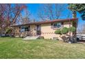 Well-maintained single-story home with brick accents, landscaped yard, and inviting entrance at 4625 S Huron St, Englewood, CO 80110