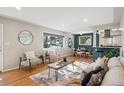 Bright living room with hardwood floors, stylish furniture, and an open layout connecting to the dining area and kitchen at 4625 S Huron St, Englewood, CO 80110
