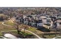 Beautiful aerial view of a neighborhood with walking paths, open spaces, and modern homes at 12242 W 56Th Pl, Arvada, CO 80002