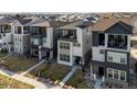 Charming two-story home with modern design, a balcony, and a well-maintained front yard at 12242 W 56Th Pl, Arvada, CO 80002